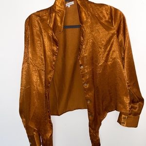 Orange, silky button down shirt.